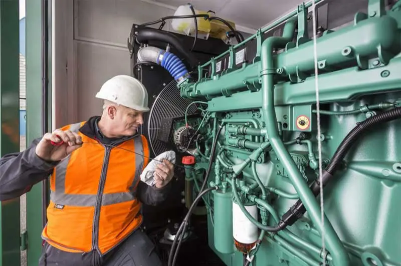 Specialist inspecting a diesel generator